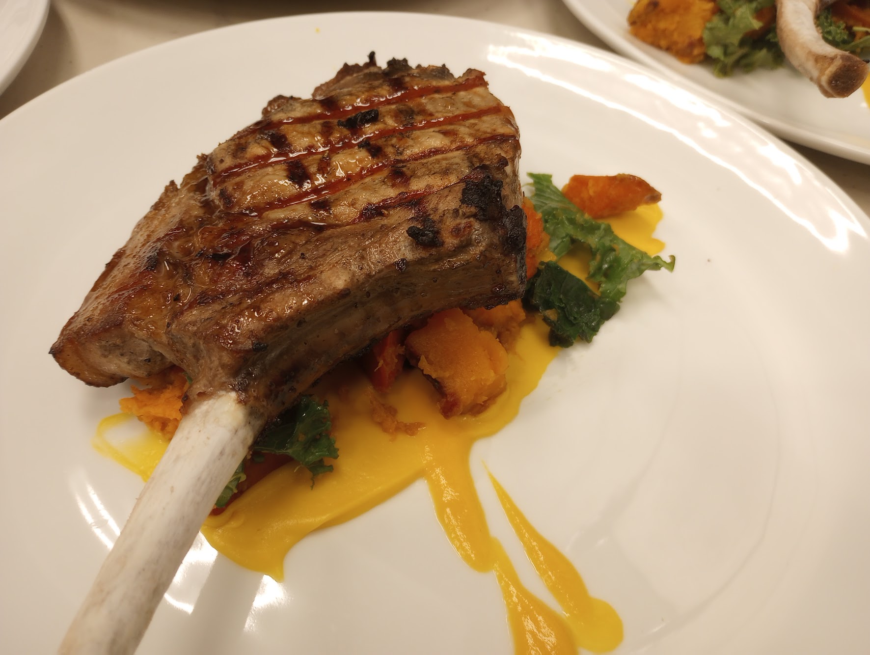 Grilled lamb chop with seasonal vegetables and golden sauce