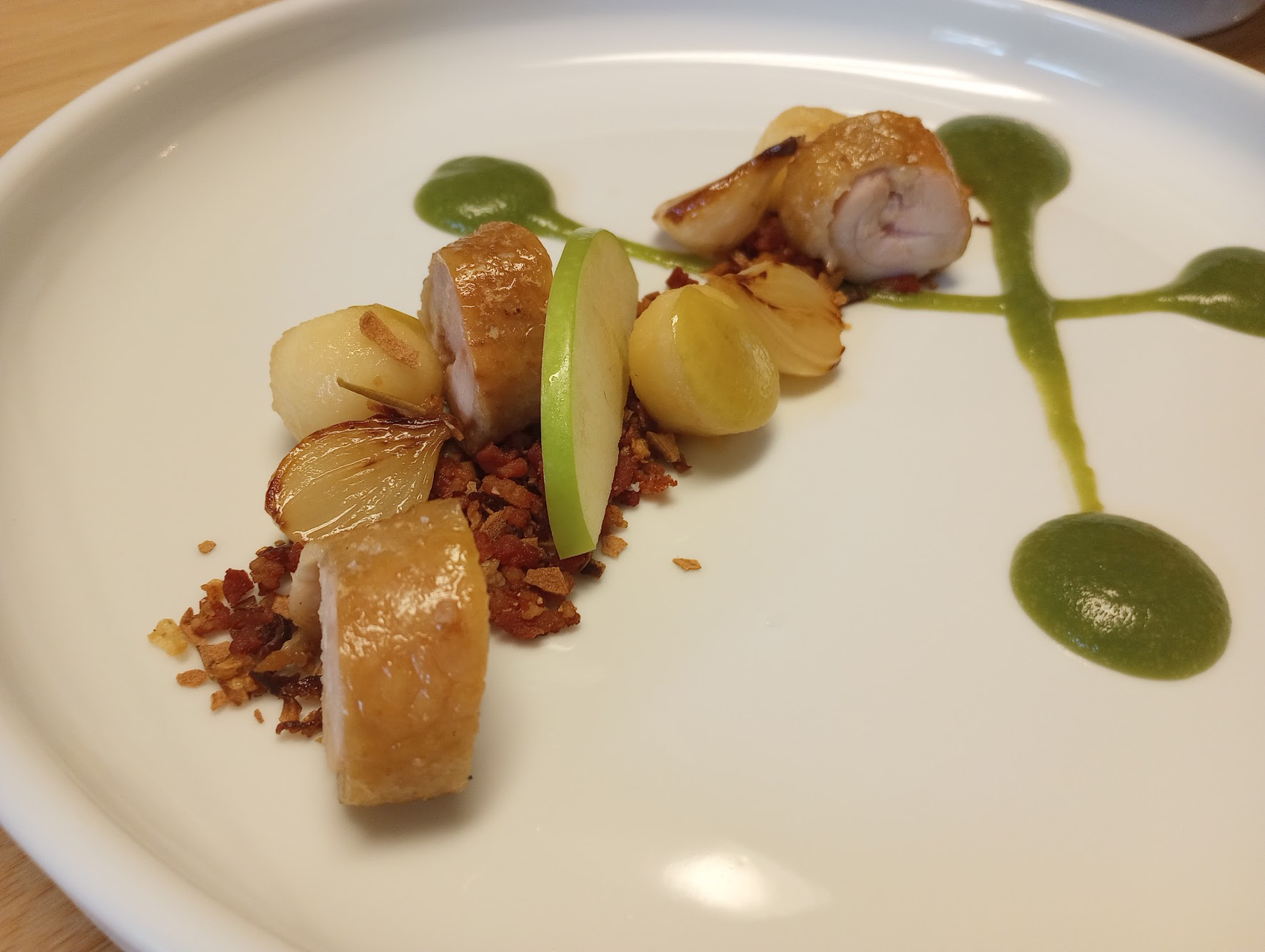 Plated poultry with herb purée and crisp crumble