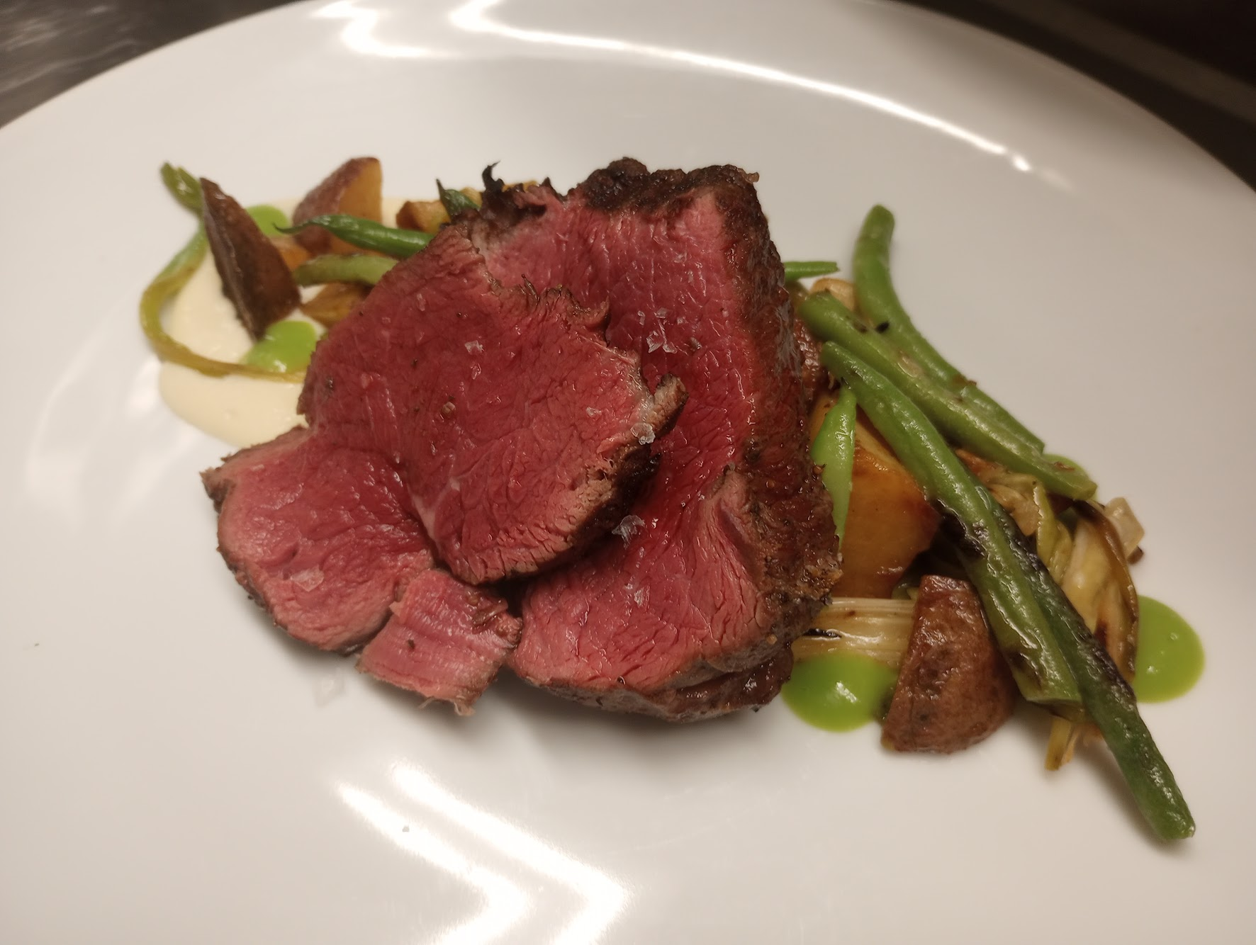 Seared beef with green beans and potatoes, plated for tasting dinner